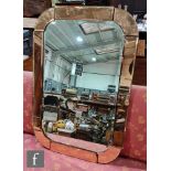 A 1930s Art Deco wall mirror with a central rectangular glass with peach mirror panel borders,