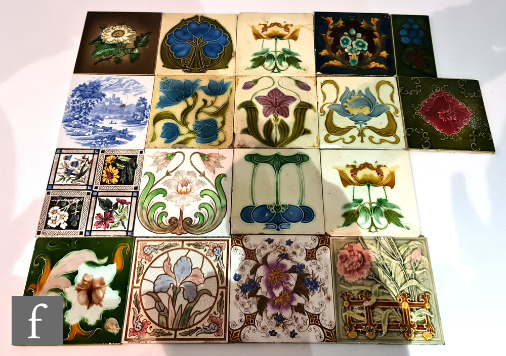 Twelve assorted early 20th Century 6in Art Nouveau dust pressed tiles each with a floral design,