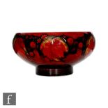 A William Moorcroft Flambe Leaf and Berry pattern bowl of footed form, circa 1930s, decorated with