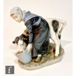 A Royal Copenhagen figure of a farm girl feeding a goat, modelled by Christian Thomsen, model 779,