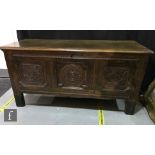 An 18th Century carved oak triple panelled coffer, the moulded edge top over a three recessed