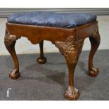 A late 19th to early 20th century Chippendale style dressing table stool on scroll carved cabriole