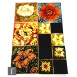 Six assorted early 20th Century Art Nouveau 6in dust pressed tiles with raised floral decorationm to