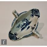 A late 18th Century Worcester twin handled sauce boat decorated with a blue and white hand painted