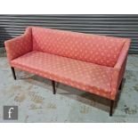 An Edwardian three seater settee upholstered in red leaf pattern on square tapering legs terminating