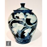 A large later 20th Century studio pottery jar and cover, the whole decorated in a sponged blue glaze
