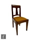 An Arts and Crafts oak side chair with a drop-in seat pad above tapered front legs tipped with