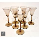 A set of seven 1930s Orrefors Sandvik Astrid wine glasses designed by Simon Gate, each with a bell