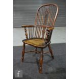 A 19th century yew wood and elm Windsor elbow chair, pierced splat on turned legs united by a