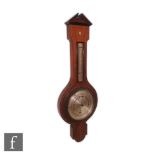 An early 20th century inlaid mahogany aneroid barometer incorporating a thermometer, decorated