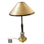 An Edwardian table lamp in patinated brass with applied pewter stiff leaf mounts to the stepped