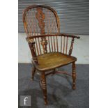 A 19th Century yew wood and elm Windsor elbow chair, pierced shaped splat on turned legs united by