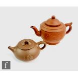 Two Chinese Yixing teapots, each of globular form with loop handles, the exterior body of each
