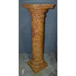 A late 20th Century speckled marble column, the dentil square top over a Doric column plinth base,