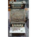 A small brass National cash register, No 46 1/4, serial no 15333, on wooden plinth base, width 29cm.