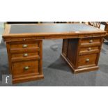 A reproduction twin pedestal desk in the Victorian style, with an inset leatherette top above