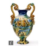 A late 19th to early 20th Century Cantagalli faience vase, decorated in the round with a hand