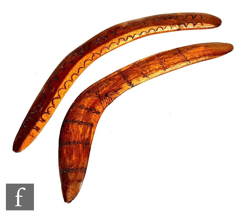 A 20th Century Australian boomerang carved with semi circular design, length 51cm and a similar