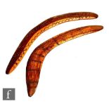 A 20th Century Australian boomerang carved with semi circular design, length 51cm and a similar