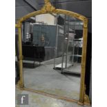 A Victorian gilt framed overmantel mirror of arched form, with an acanthus pediment over stiff