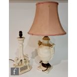 Two later 20th Century Classical Creamware table lamps, the first modelled with two griffins