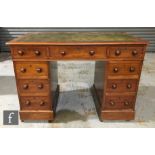 A late Victorian mahogany twin pedestal desk of small proportions, with inset green leather top
