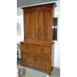 A George III mahogany secretaire bookcase enclosed by a pair of panelled doors below a projecting