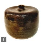 A later 20th Century studio pottery vase of compressed barrel form with an indented neck, the