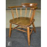 A 20th century elm and beech smoker's bow style elbow chair.