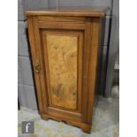 A Victorian walnut bedside cupboard enclosed by a panelled door on shaped plinth base, width 39cm.