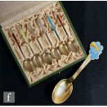 A cased set of six Norwegian silver gilt and enamelled decorated teaspoons each with a differing