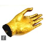 A 19th Century Tibetan gilt copper alloy buddha hand, the sectional hand with open palm and gently