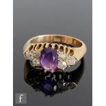 A 18ct amethyst and diamond ring, central oval amethyst flanked by three old cut diamonds to