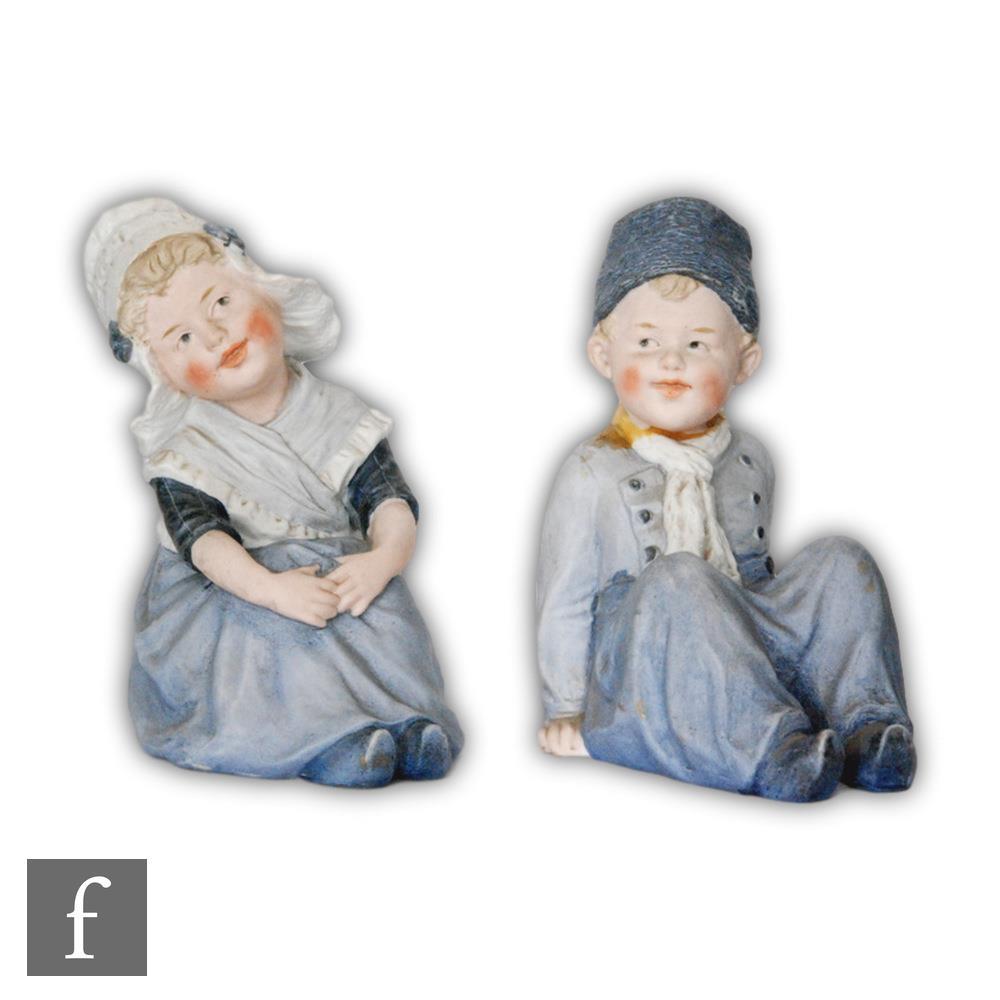 A pair of late 19th Century Gebruder Heubach bisque piano babies modelled as a Dutch boy, S/D, and
