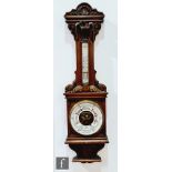A late 19th Century carved oak barometer by F.J Gould Birmingham, incorporating a thermometer,