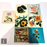 Seven assorted early 20th Century 6in Art Nouveau dust pressed tiles each with a floral design to