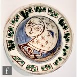 A later 20th Century studio pottery bowl decorated with an incised figure holding a scroll in the