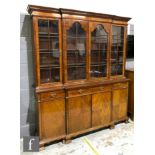 A 20th Century mahogany break-fronted bookcase in the George III style,