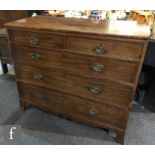 A George IV mahogany chest of two short over three long drawers with replacement brass drop handles,
