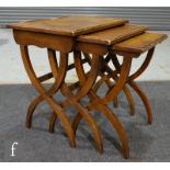 A nest of three late 20th Century walnut occasional tables in the Regency style by 'Reprodux',