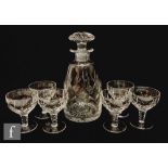 A Stuart Crystal glass decanter and six small drinking glasses in the Carlingford pattern, the