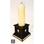 A later 20th Century Wedgwood candlestick, the square pillar body in black basalt with ochre lion