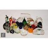 A collection of paperweights of various forms, to include assorted Mdina examples including chess