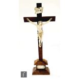 A late 19th century finely carved French Dieppe ivory crucifix mounted on oak cross below the nailed