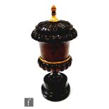 A 19th century hardwood and ebony campana urn shaped snuff container, the cover mounted with a