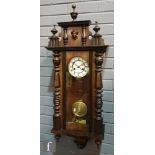A late 19th Century walnut and stained beechwood regulator wall clock with spring driven movement