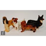 Four Beswick dogs comprising a Jack Russell terrier, an Afghan hound Hajubah of Davlen, a corgi