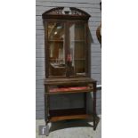 A late 19th to early 20th Century carved mahogany Chippendale style floorstanding display bijouterie