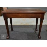 A George III mahogany fold-over tea table, with plain apron over claw and ball feet, height 72cm and