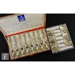 A boxed set of eight hallmarked silver British monarch tea spoons